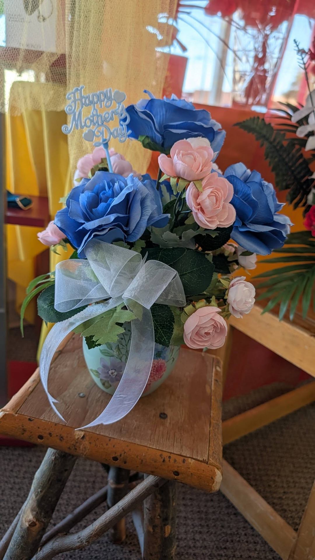 Mother's Day blue rose and pink peony arrangement with silver bow.