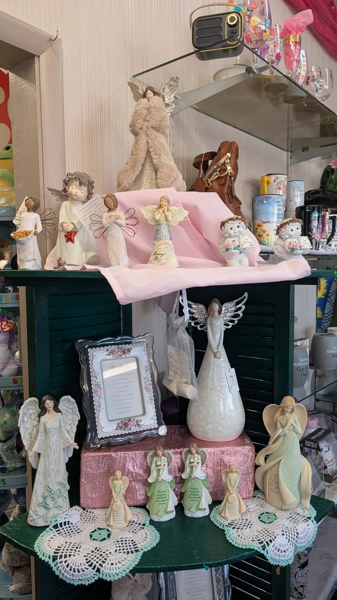 Shelf full of angel figurines and inspirational keepsake gifts.